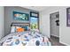 Colorful bedroom featuring rocket ship decor, a patterned bedspread, and closet at 13253 Tropical Breeze Way, Hudson, FL 34669