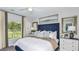 Cozy bedroom featuring a queen-sized bed, plush pillows, decorative headboard, and a large window at 13253 Tropical Breeze Way, Hudson, FL 34669
