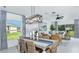 Inviting dining area featuring stylish decor, modern lighting, and an open layout to the living area at 13253 Tropical Breeze Way, Hudson, FL 34669