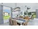 Inviting dining area with stylish furniture, modern lighting, and views of the backyard at 13253 Tropical Breeze Way, Hudson, FL 34669