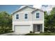 Charming two-story home with light grey siding, white trim, and a two car garage at 13279 Tropical Breeze Way, Hudson, FL 34669