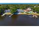 Aerial view highlighting the property's proximity to the water, private dock, and screened pool area at 13548 Lake Magdalene Dr, Tampa, FL 33613