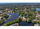 Picturesque aerial view of the neighborhood featuring homes nestled along the tranquil lake and lush landscaping at 13548 Lake Magdalene Dr, Tampa, FL 33613