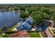 Aerial view showcasing waterfront property featuring a private dock, screened lanai, and lush backyard at 13548 Lake Magdalene Dr, Tampa, FL 33613