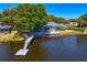 Gorgeous lakefront home with a private dock, screened-in lanai and spacious deck for outdoor enjoyment at 13548 Lake Magdalene Dr, Tampa, FL 33613