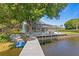 Spacious backyard with screened lanai, patio, and private dock access to the lake at 13548 Lake Magdalene Dr, Tampa, FL 33613