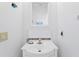 A simple bathroom features a sink and a decorative fish on the wall at 13548 Lake Magdalene Dr, Tampa, FL 33613