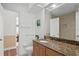 Bathroom with granite vanity and view of the commode at 13548 Lake Magdalene Dr, Tampa, FL 33613