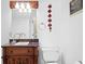 A decorated powder room featuring a sink, toilet, and decorative elements at 13548 Lake Magdalene Dr, Tampa, FL 33613