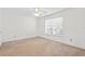 A bedroom with neutral carpet and white walls, featuring one window at 13548 Lake Magdalene Dr, Tampa, FL 33613