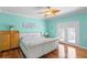 Bright bedroom with hardwood floors, dresser and sliding doors at 13548 Lake Magdalene Dr, Tampa, FL 33613