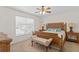 Bedroom with large window and a bench at 13548 Lake Magdalene Dr, Tampa, FL 33613