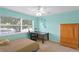 Bright bedroom with large window, desk, and striped bedspread at 13548 Lake Magdalene Dr, Tampa, FL 33613