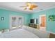 Bedroom with hardwood floors and doors to the patio at 13548 Lake Magdalene Dr, Tampa, FL 33613