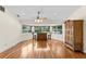 Open bonus room with beautiful hardwood floors, bay windows, and bar seating with views of the lake at 13548 Lake Magdalene Dr, Tampa, FL 33613