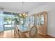 Bright dining area with views of the pool, features a glass table, and display case at 13548 Lake Magdalene Dr, Tampa, FL 33613
