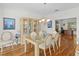 Comfortable dining room featuring hardwood floors, display case, and glass table at 13548 Lake Magdalene Dr, Tampa, FL 33613