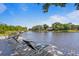 Dockside view featuring lounge chairs and a table perfect for enjoying the waterfront views at 13548 Lake Magdalene Dr, Tampa, FL 33613