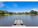 Lakefront property featuring private dock for recreational use and access to the water at 13548 Lake Magdalene Dr, Tampa, FL 33613