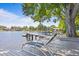 Waterfront property features a private dock with lounge chairs, perfect for relaxing by the lake at 13548 Lake Magdalene Dr, Tampa, FL 33613