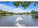 Lakefront property featuring private dock for recreational use and access to the water at 13548 Lake Magdalene Dr, Tampa, FL 33613