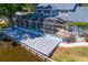 Charming lakefront property featuring a screened pool, large patio deck, and access to the lake at 13548 Lake Magdalene Dr, Tampa, FL 33613