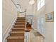 Grand foyer with a soaring ceiling, elegant chandelier, and staircase leading to upper level at 13548 Lake Magdalene Dr, Tampa, FL 33613