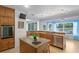 Spacious kitchen featuring stainless steel appliances, an island, and water views at 13548 Lake Magdalene Dr, Tampa, FL 33613