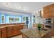 Open-concept kitchen featuring stainless steel appliances and a beautiful water view at 13548 Lake Magdalene Dr, Tampa, FL 33613