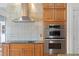 Close up of kitchen with stainless steel appliances, wooden cabinets, and granite countertops at 13548 Lake Magdalene Dr, Tampa, FL 33613