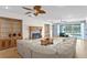 Cozy living room with fireplace, built-in cabinets, and a large window overlooking the lake at 13548 Lake Magdalene Dr, Tampa, FL 33613