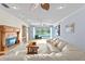 Beautiful living room with fireplace and a view of the lake from the oversized sliding doors at 13548 Lake Magdalene Dr, Tampa, FL 33613