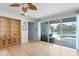 Bright living room with tile floors, built-in shelving, and sliding glass doors to the pool at 13548 Lake Magdalene Dr, Tampa, FL 33613