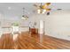 Upstairs living area with hardwood floors, a chandelier, and an open view of downstairs at 13548 Lake Magdalene Dr, Tampa, FL 33613
