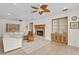 Living room featuring a fireplace, built-in cabinets, large windows, and decorative ceiling fan at 13548 Lake Magdalene Dr, Tampa, FL 33613