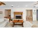 Open living room featuring custom built-in cabinets, a fireplace, and a decorative ceiling fan at 13548 Lake Magdalene Dr, Tampa, FL 33613