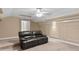 A cozy media room features comfortable, leather seating at 13548 Lake Magdalene Dr, Tampa, FL 33613