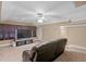 A cozy media room features a large screen TV and comfortable, leather seating at 13548 Lake Magdalene Dr, Tampa, FL 33613