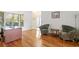A home office featuring hardwood floors, large windows, and comfortable arm chairs at 13548 Lake Magdalene Dr, Tampa, FL 33613