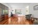 A home office featuring hardwood floors, large windows and a comfortable seating area at 13548 Lake Magdalene Dr, Tampa, FL 33613