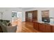 A home office featuring hardwood floors, large windows, built-in bookcase and furniture at 13548 Lake Magdalene Dr, Tampa, FL 33613