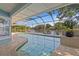 This screened in pool area has lots of seating, lush plants, and a view of the lake at 13548 Lake Magdalene Dr, Tampa, FL 33613