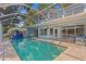A lovely screened pool is a major feature of this home's exterior at 13548 Lake Magdalene Dr, Tampa, FL 33613