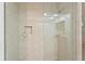 Tiled shower with glass door and gold fixtures at 13548 Lake Magdalene Dr, Tampa, FL 33613