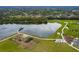 A stunning aerial view of the park's pond with a dock, playground, walking paths, and other amenities at 13608 S Village Dr # 6203, Tampa, FL 33618