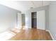 Bright bedroom features wood floors, a closet and a doorway to another room at 13608 S Village Dr # 6203, Tampa, FL 33618