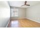 Bright bedroom with hardwood floors, large window, and neutral paint at 13608 S Village Dr # 6203, Tampa, FL 33618