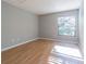 Bedroom with neutral walls, wood flooring, and a window letting in natural light at 13608 S Village Dr # 6203, Tampa, FL 33618