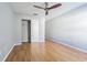 Light bedroom with ceiling fan, closet, and bright wood floors at 13608 S Village Dr # 6203, Tampa, FL 33618