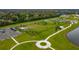 Aerial view of the fenced dog park with mature trees, walking paths, and shelter, surrounded by green space at 13608 S Village Dr # 6203, Tampa, FL 33618